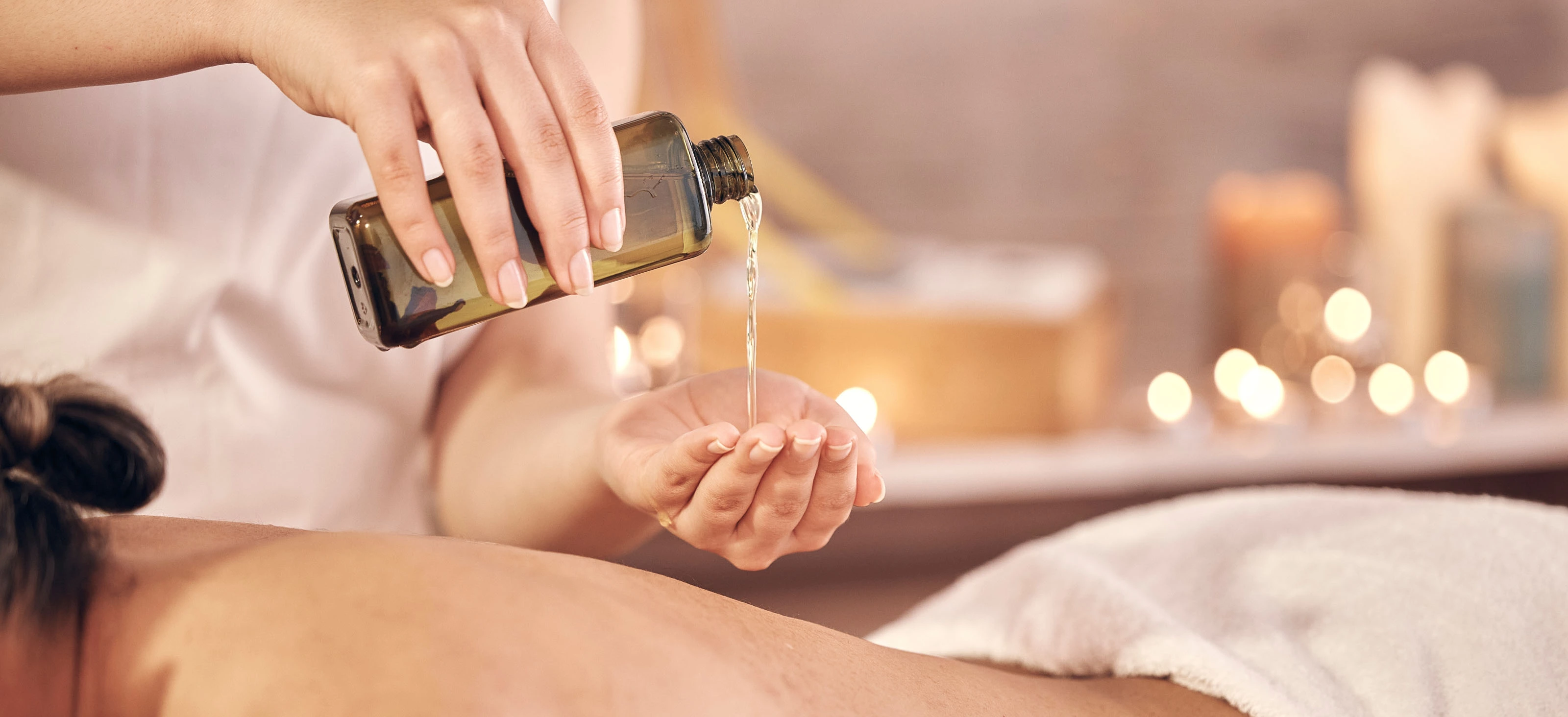 Massage with hot organic argan and jojoba oils